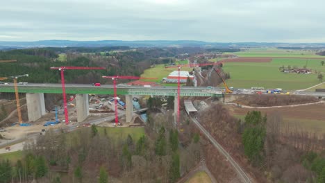 industrial crane towering on highway bridge construction site