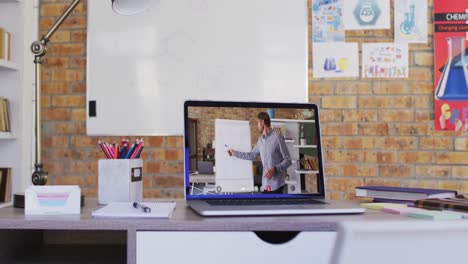 Caucasian-male-teacher-displayed-on-laptop-screen-during-video-call