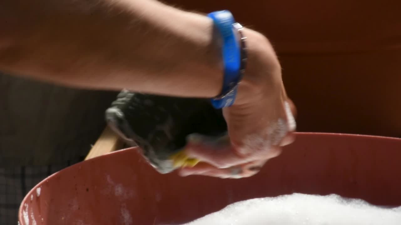 Scrub down cleaning of flower pot with soap and water close up