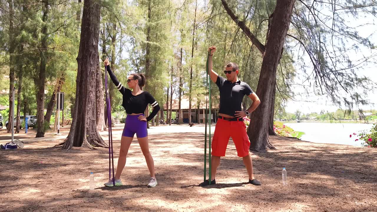Couple Workout with Resistance Bands in a Park