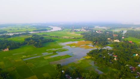 flooded paddy farmland and rural village in bangladesh - aerial drone shot