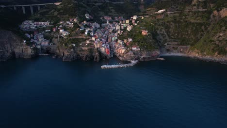 aerial view reveals dramatic mountainous setting of riomaggiore, italy