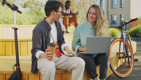 Multiethnic-Female-Freelancers-Speaking-and-Working-in-Park