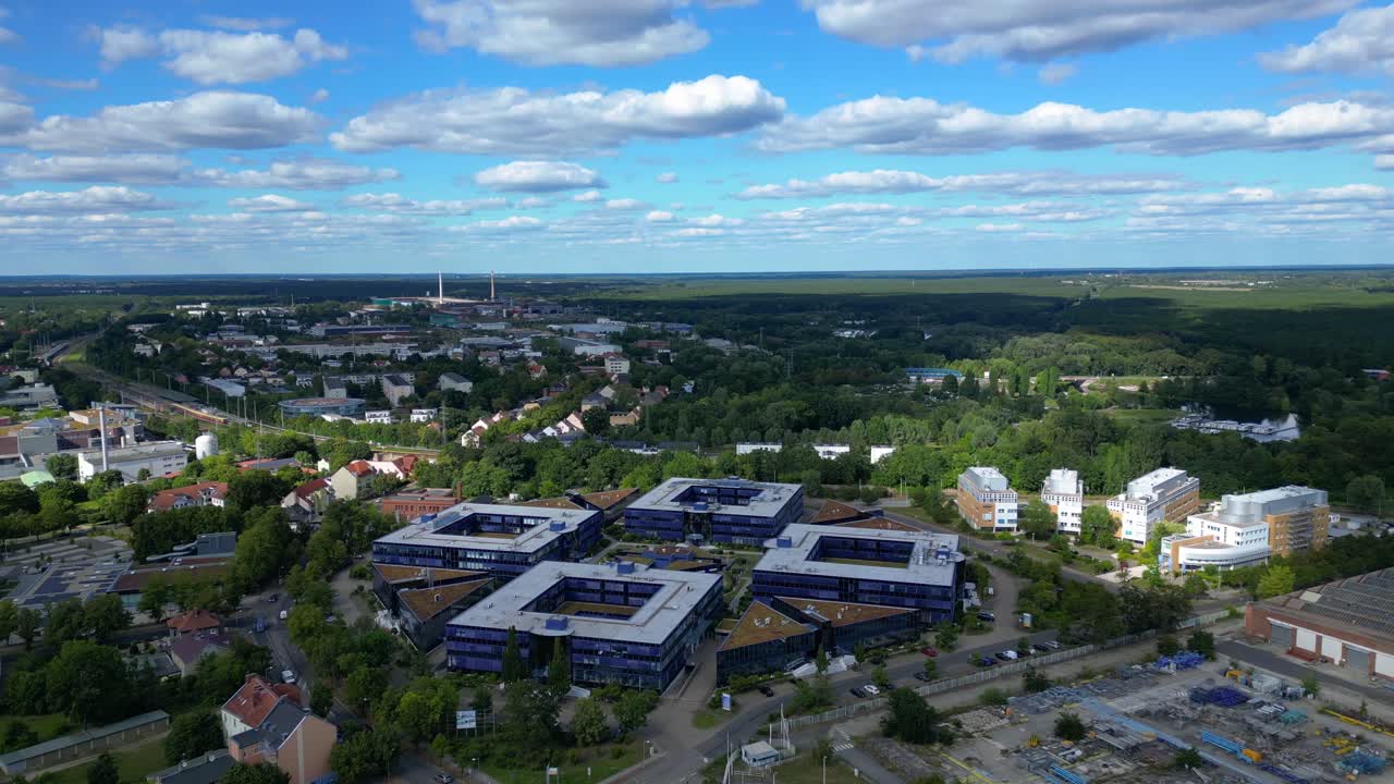 Hennigsdorf, Germany, showcasing residential areas, railway infrastructure and commercial buildings. Unique aerial view flight panorama overview drone