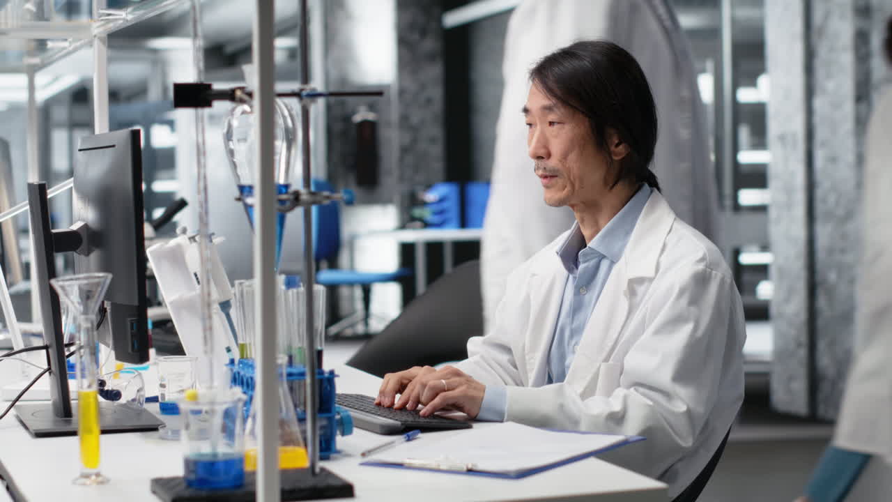 Vertical video Senior laboratory scientist feeling neck ache while using PC to log patient data