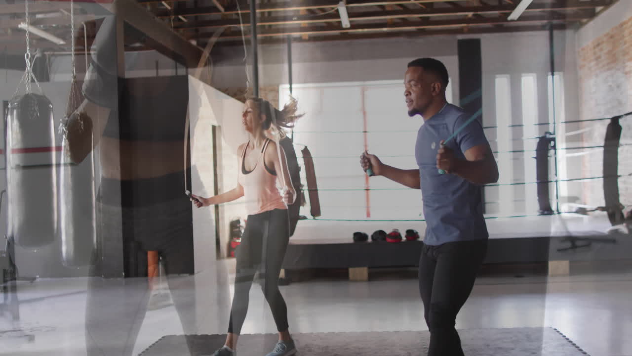 Jumping rope energetically, two people in gym with animation and boxing equipment