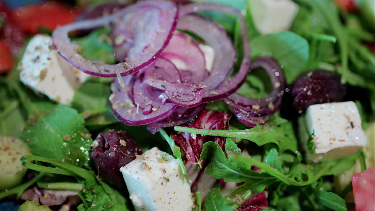 Close up of a woman cutting up raw beef on a wooden cutting board
