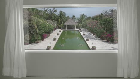 view from the hotel room to calm tropical resort with garden and pool. background plate, chroma key video background