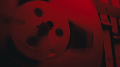 a close-up on a vintage tape recorder in a red blinking light