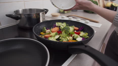 verduras cayendo en la sartén en cámara lenta de cerca