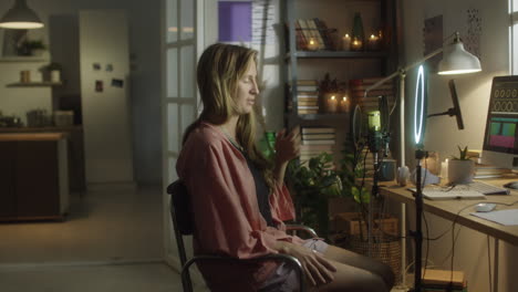 woman live streaming on social media at home studio