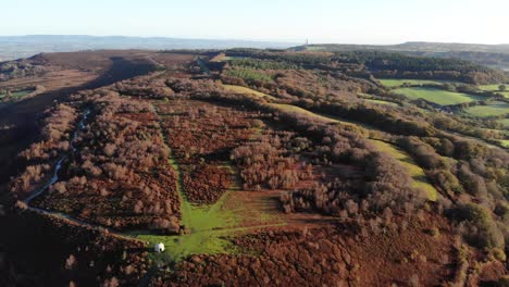 Aerial-rotating-view-of-Culmstock-Beacon-Devon-England-with-Wellington-Monument-in-the-far-distance