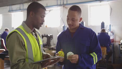 two colleagues discussing in factory