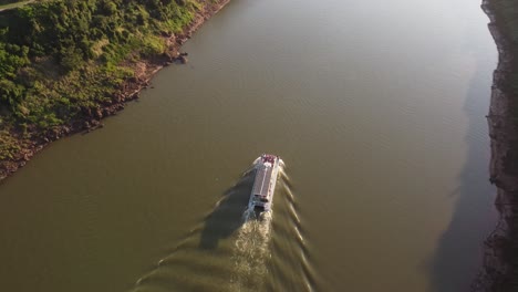 drone footage of a tourist boat at sunset on the iguazu river on the argentina-brazil border in south america