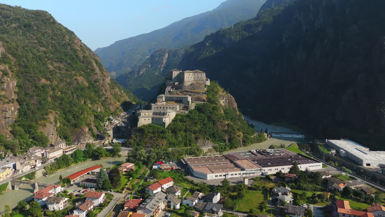 Fort bard in aosta valley, italy surrounded by mountains and a village, aerial view