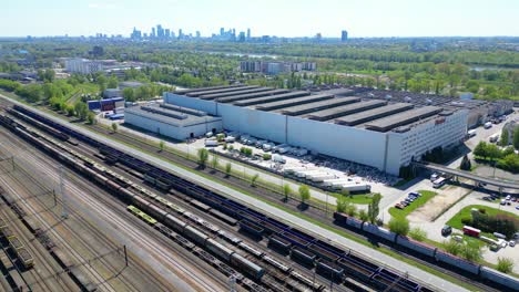 Flying-above-industrial-railroad-station-with-cargo-trains-and-freight-containers