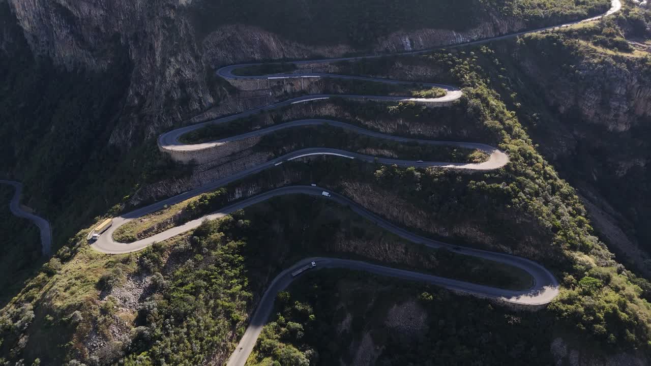 Top-down aerial of the famous Leba Pass switchbacks, showcasing its unique curves carved into the rugged Angolan mountain