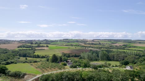 Aerial-ascending-view-over-Brittany-rural-landscape-in-France