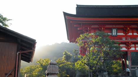 Slide-shot-of-the-sunrise-appearing-from-behind-the-mountains-in-Kyoto,-Japan-4K-slow-motion