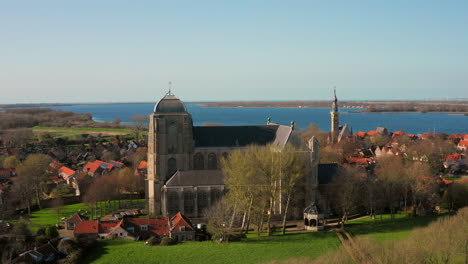 Aerial:-The-historical-town-of-Veere-with-an-old-harbour-and-churches,-on-a-spring-day