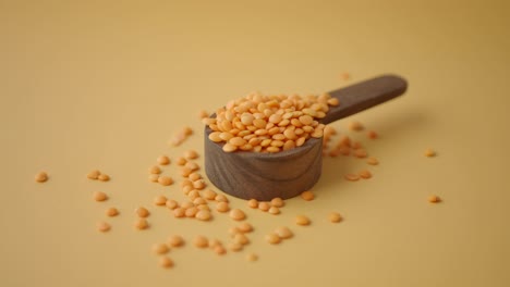 red lentils in wooden spoon