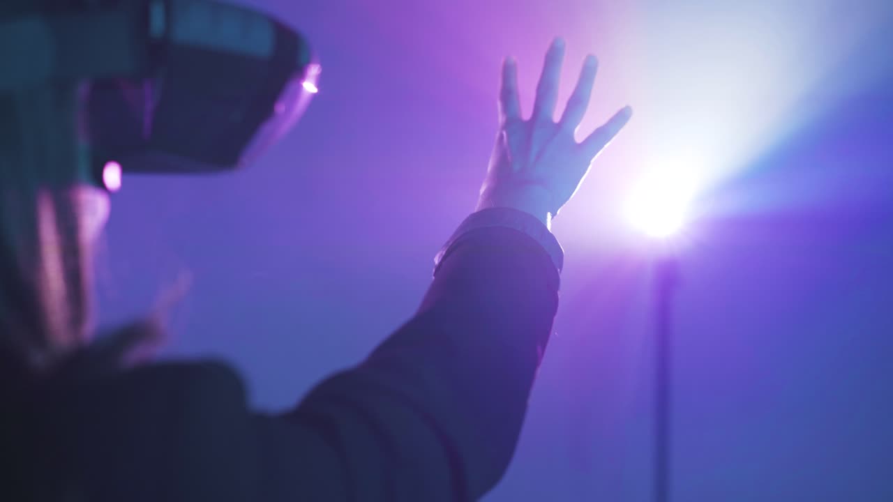 Anonymous woman in VR goggles in neon light