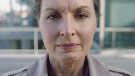 close up portrait of serious mature business woman leader looking up at camera confident focused on corporate career