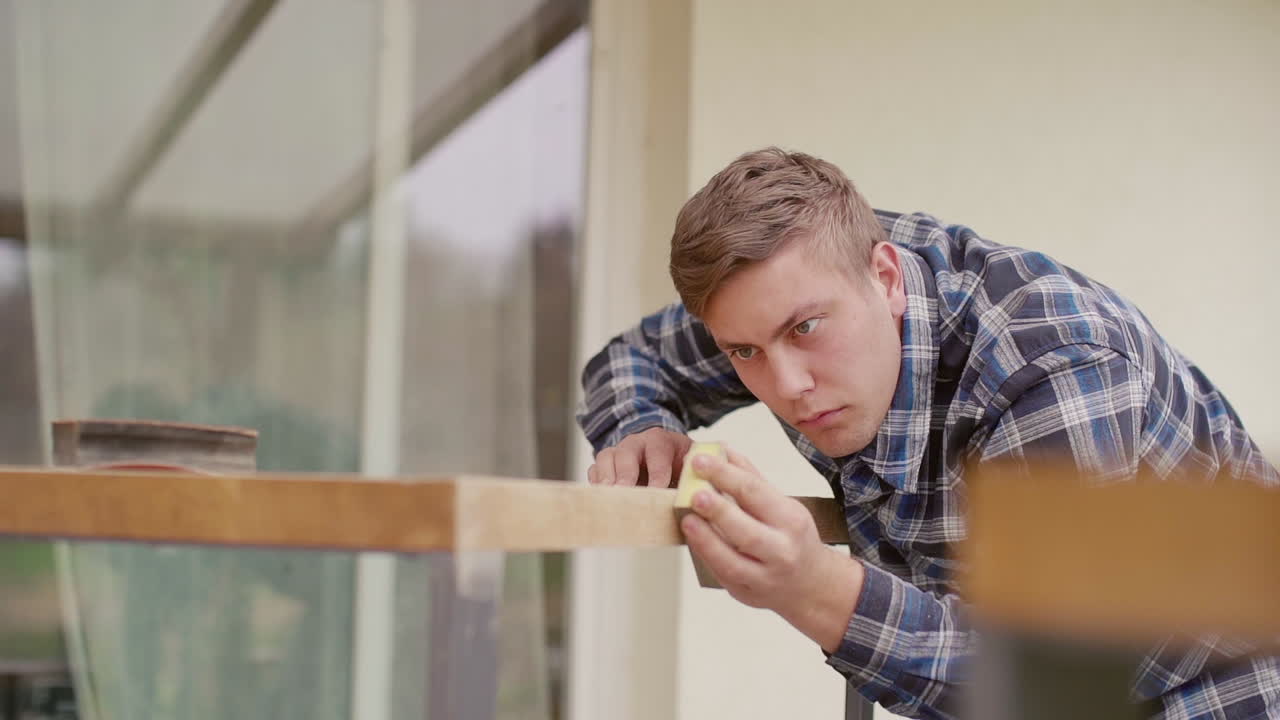 Man Sanding a Wooden Table
