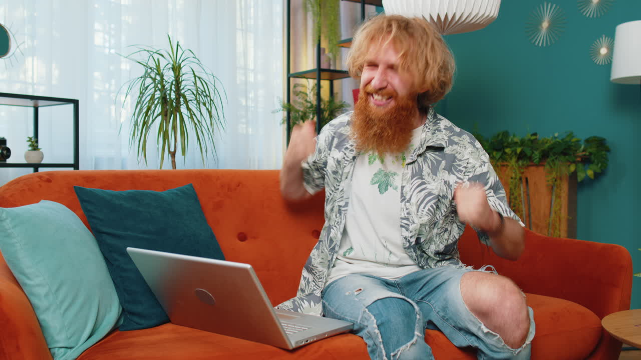 Amazed young man use laptop computer receive good news message shocked by victory celebrate win