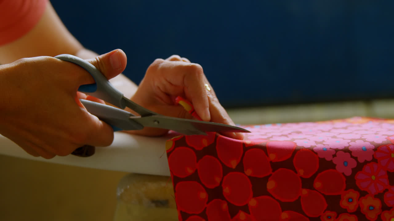 Woman cutting fabric for surfboard 4k