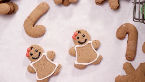 decorating gingerbread cookies with royal icing for christmas.