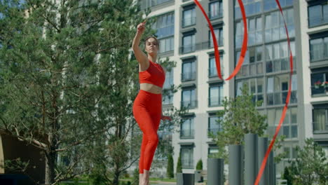 woman performing ribbon dance outdoors