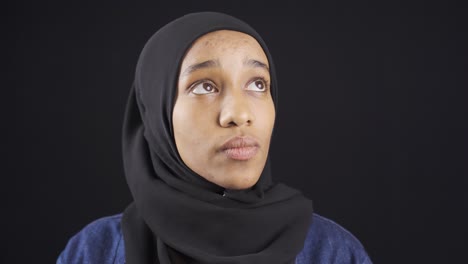 portrait of unhappy and thoughtful african muslim young woman in hijab.