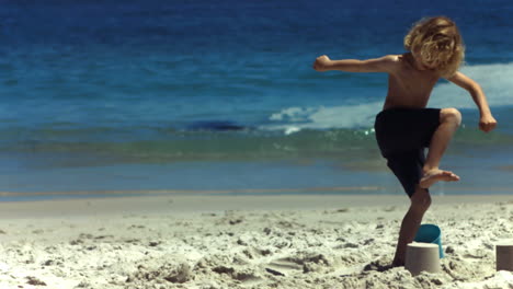 Child-crushing-a-sand-castle-in-slow-motion