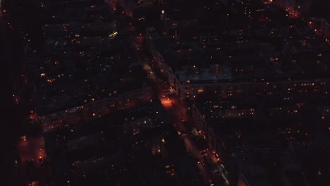 Scenic-aerial-Berlin-city-night-panorama-with-cars-in-streets-and-illuminated-block--nighbourhood-buildings.Aerial-panning-top-down-circling-view