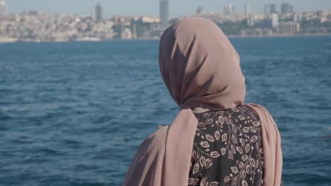 woman in hijab with city view