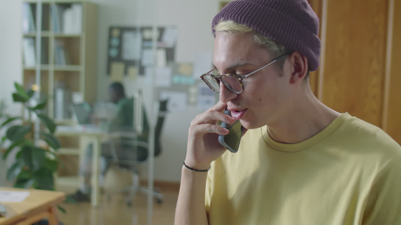 Gen Z Man Having Phone Talk in Office