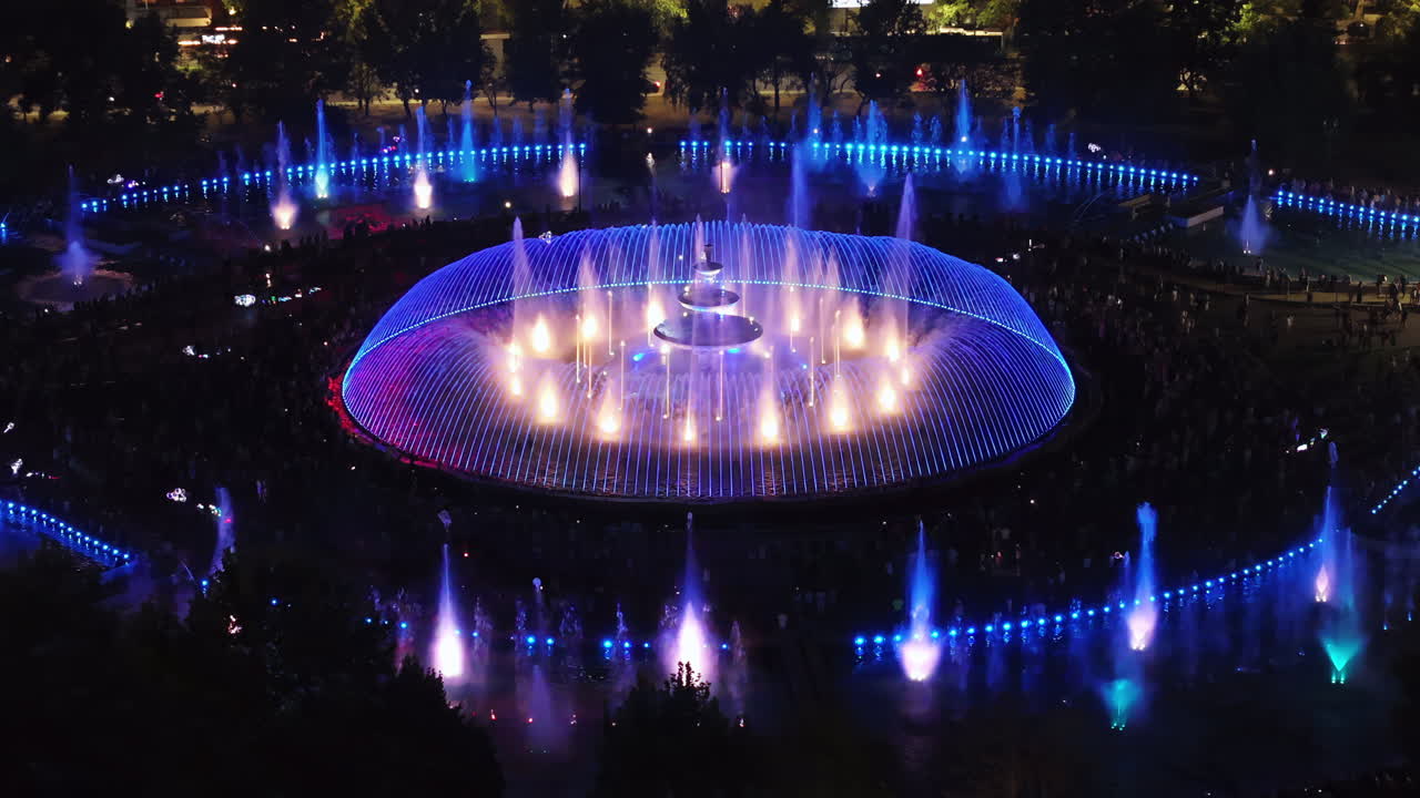 Aerial drone view of the illuminated Bucharest fountains in Romania, at night
