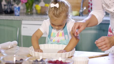 Cute-little-girl-greasing-a-baking-dish