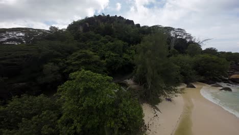 Fpv-drone-flying-on-a-beautiful-beach-in-Seychelles-on-an-Island-Mahe,-video-of-incredible-trees,-Seychelles-rocks,-seaside,-and-surrounding-Seychelles-landscapes