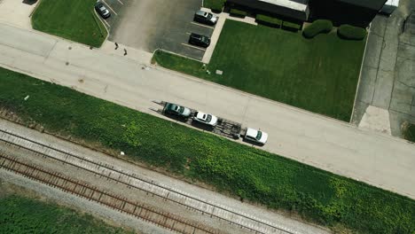 car hauler parked next to railroad 4k drone footage