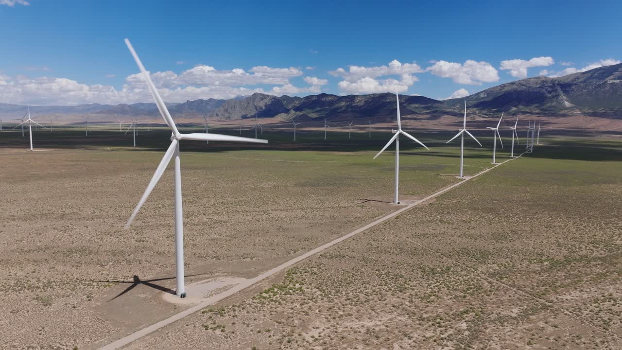 Wind turbines in Nevada desert under clear blue skies, USA perspective