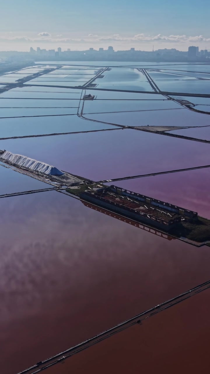 Salt production site with large salt flats and bright sky above