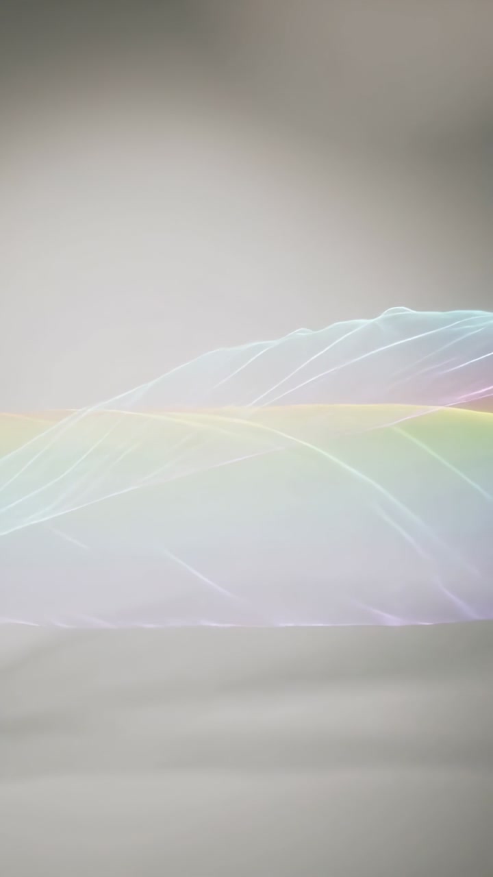 Vertical video: Screensaver activating, ribbon forming layered rainbow waves for digital wallpaper
