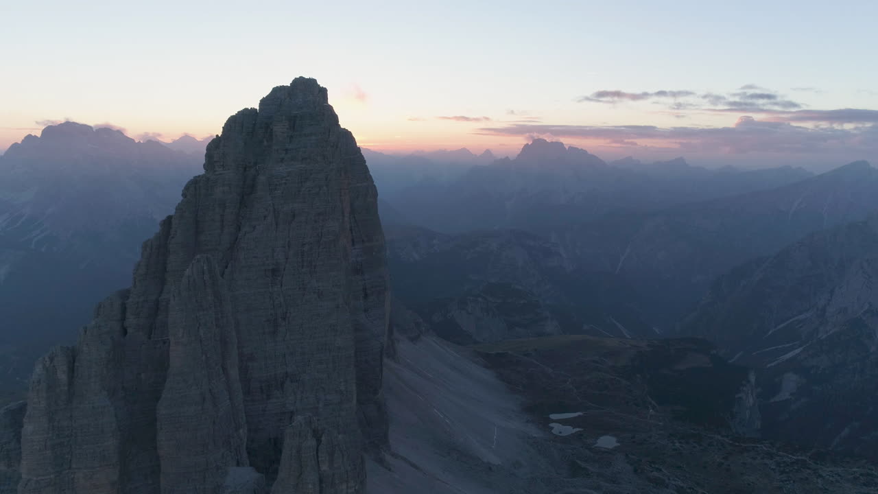 Aerial view stunning golden sunrise disappearing behind sharp Tre Cime mountain summit