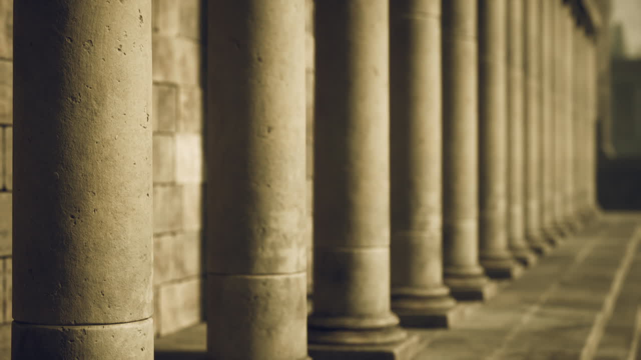 Classic stone columns create a majestic architectural perspective in the city
