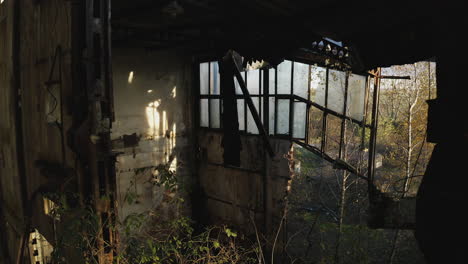 aerial smooth shot of old warehouse with collapsing roof