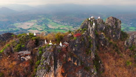 aerial drone orbit of wat chaloem phra kiat phrachomklao rachanusorn, temple of the floating pagodas, lampang, northern thailand.