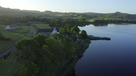 parke's castle, dromahair, leitrim, ireland, june 2021. drone slowly orbits along the coast of lough gill, while descending and pushing along the southern wall ending on the eastern facade