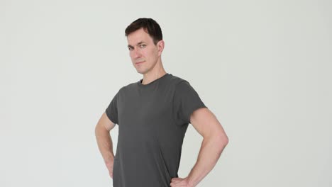 man posing or experiencing back discomfort on white background